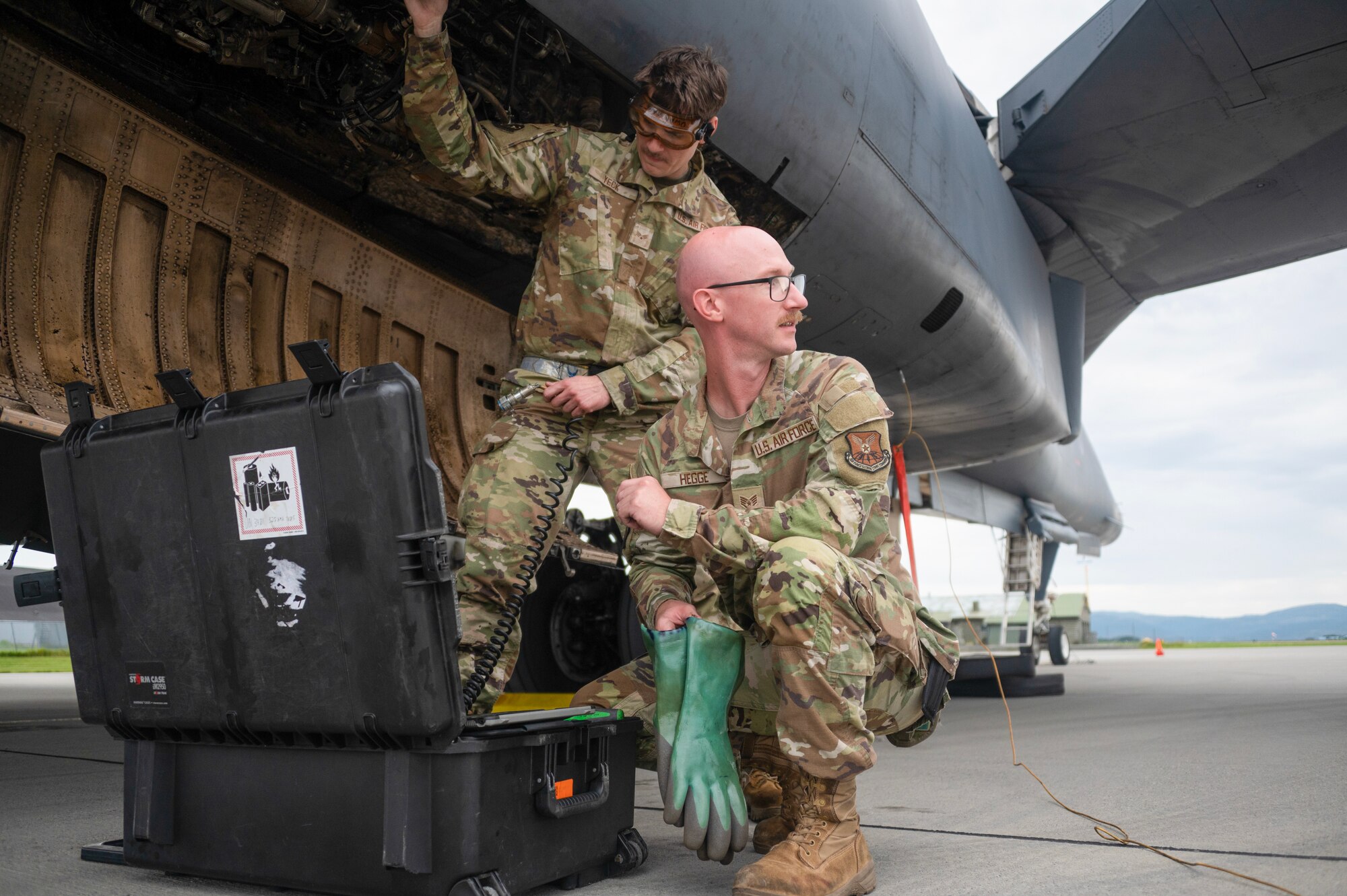 An airman walks around a plane