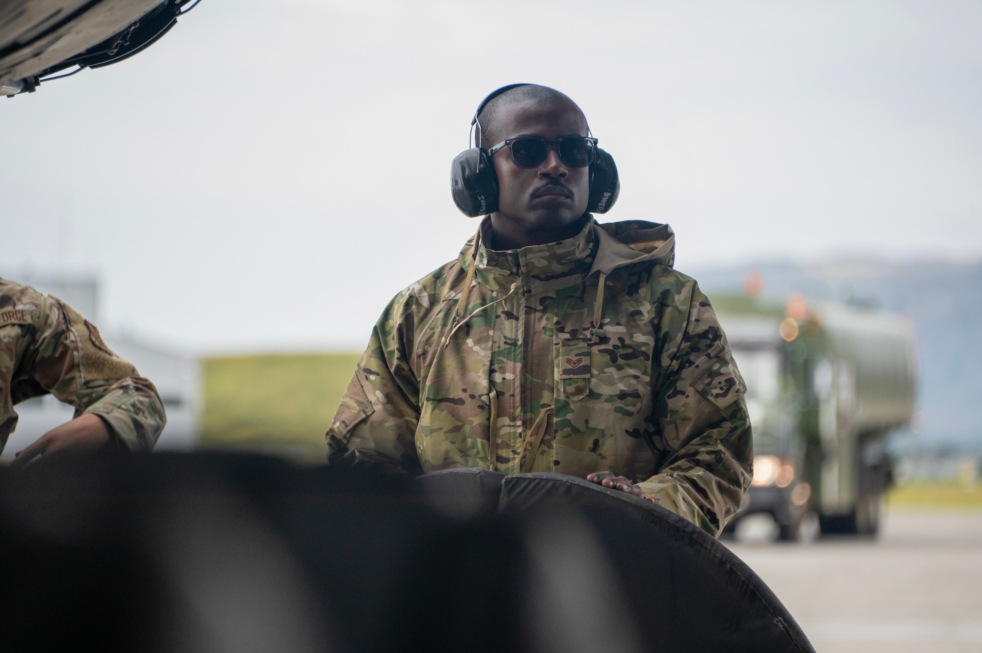 An airman walks around a plane