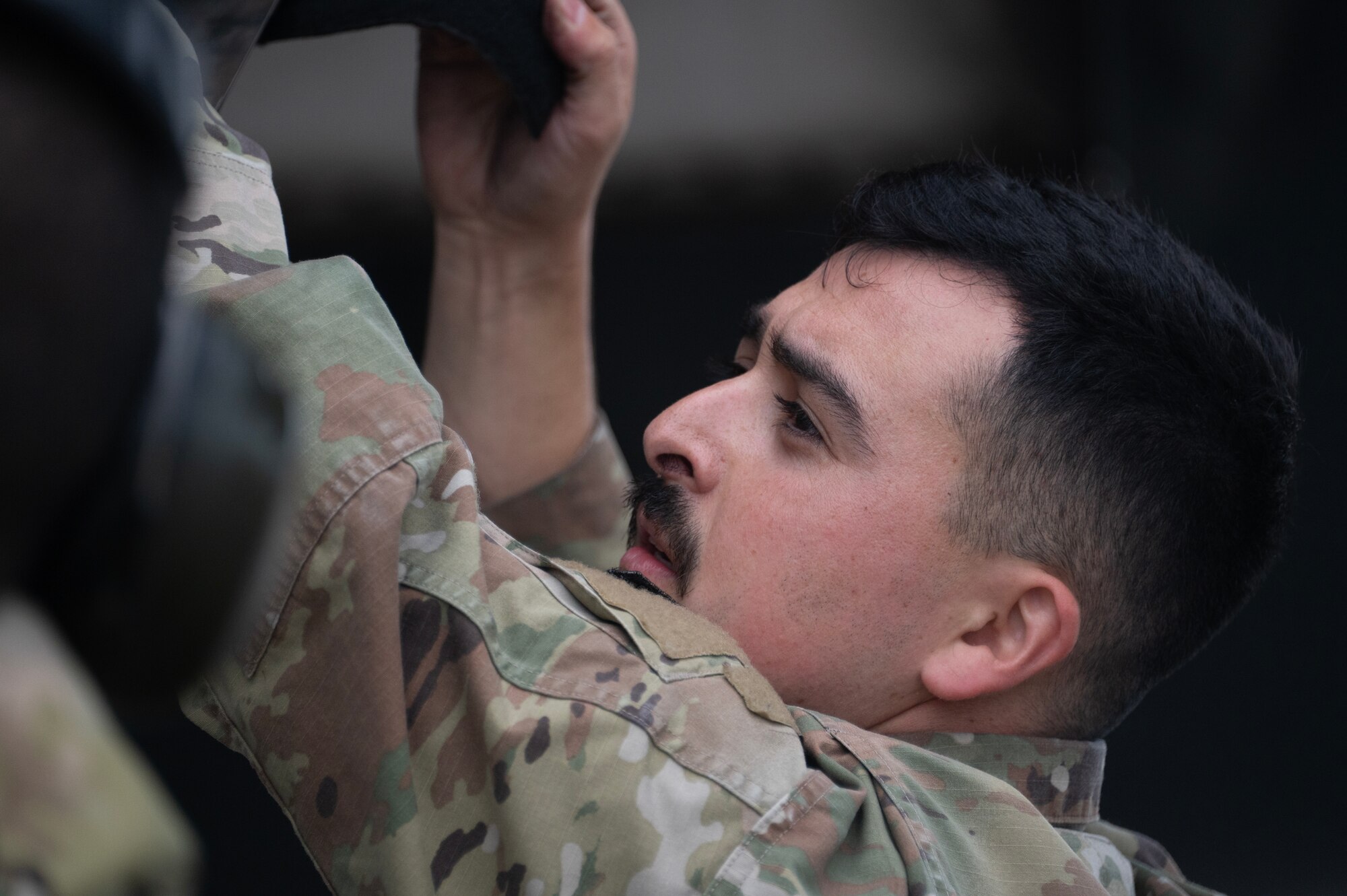 An airman walks around a plane
