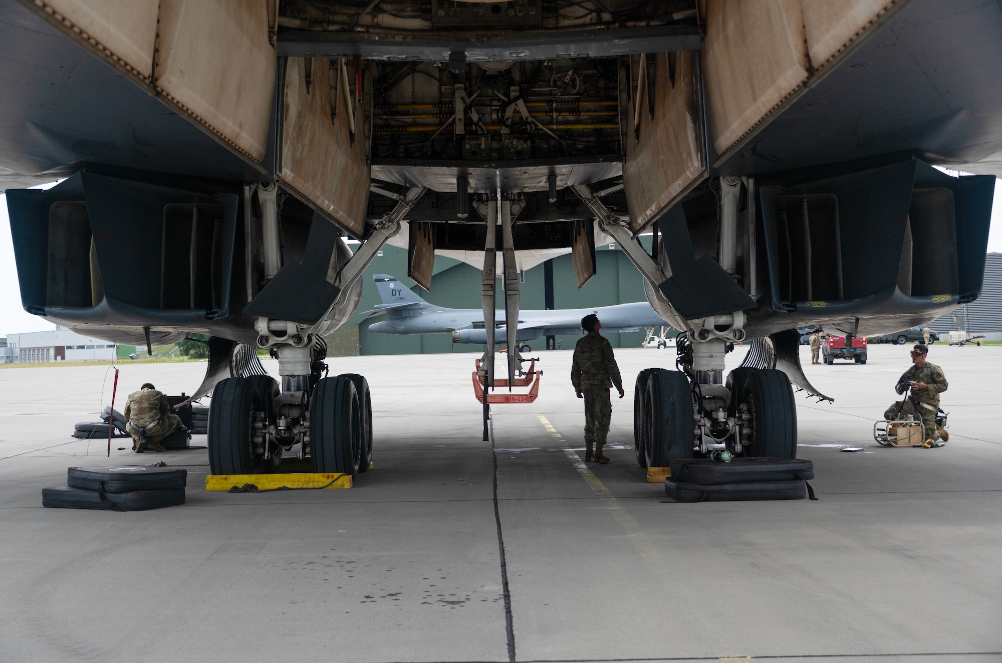 An airman walks around a plane