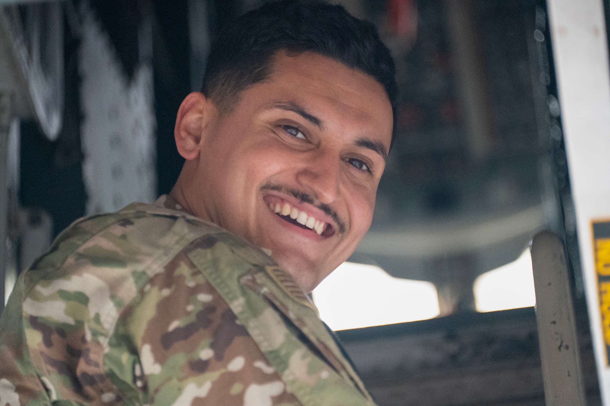 An airman walks around a plane