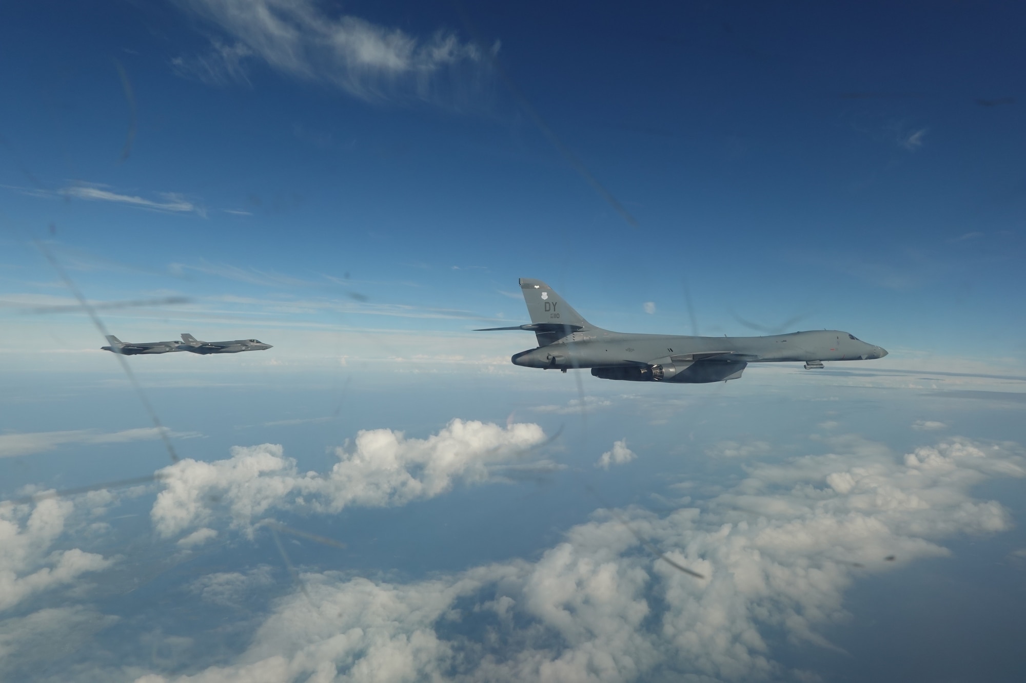 An airman walks around a plane