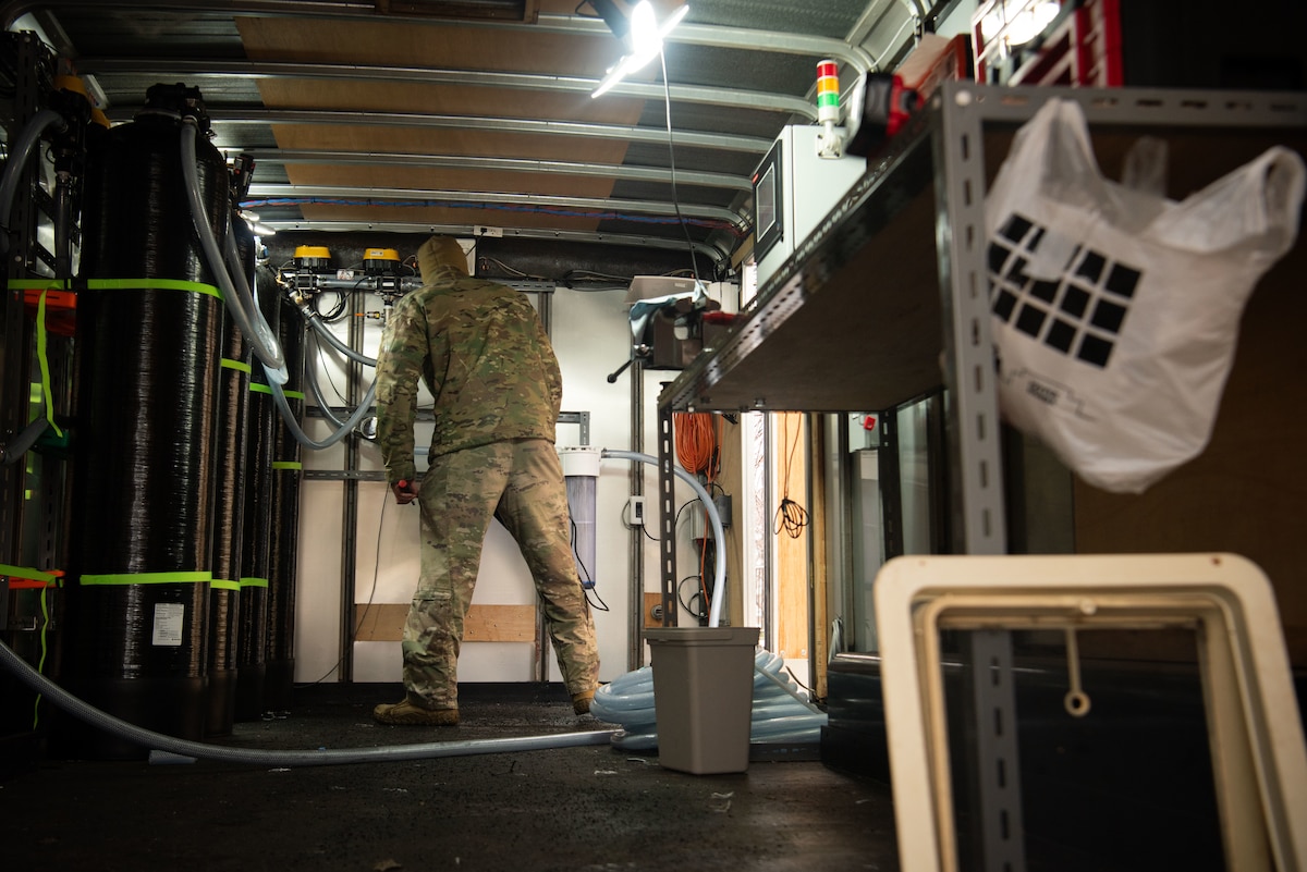 Personnel inside a small shed