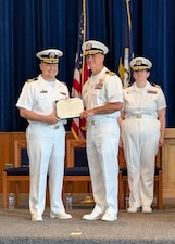 250812-O-NJ594-1210, GREAT LAKES, Illinois (Aug. 12, 2025) Capt. Darryl Arfsten, commander, Navy and Marine Corps Force Health Protection Command (NMCFHPC) and director, Defense Center for Public Health – Portsmouth (DCPH P), center, presents Cmdr. Jason Schmittschmitt, outgoing commanding officer of Navy Drug Screening Lab Great Lakes (NDSL GL), left, with an Navy and Marine Corps Accommodation medal  for his dedication and exemplary service at NDSL GL, during a change of command ceremony in Great Lakes, Illinois, August 12, 2025. Schmittschmitt will be retiring from the Navy in October. (U.S. Navy photo by Lt. Cmdr. Dan Xu)