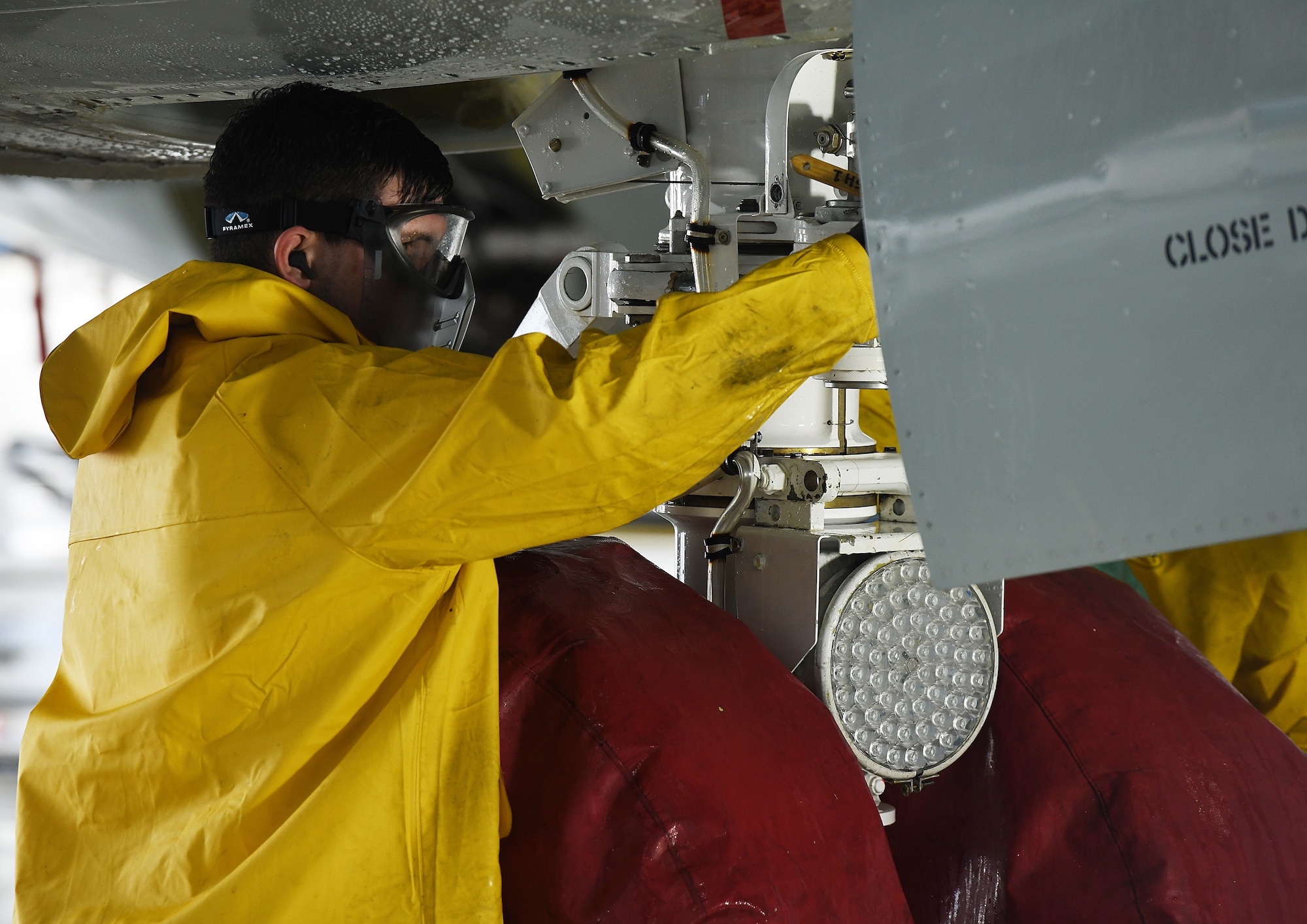 Airman washes aircraft for safety.