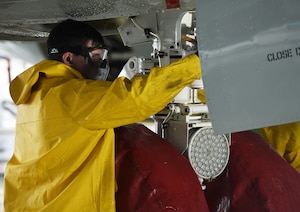 Airman washes aircraft for safety.