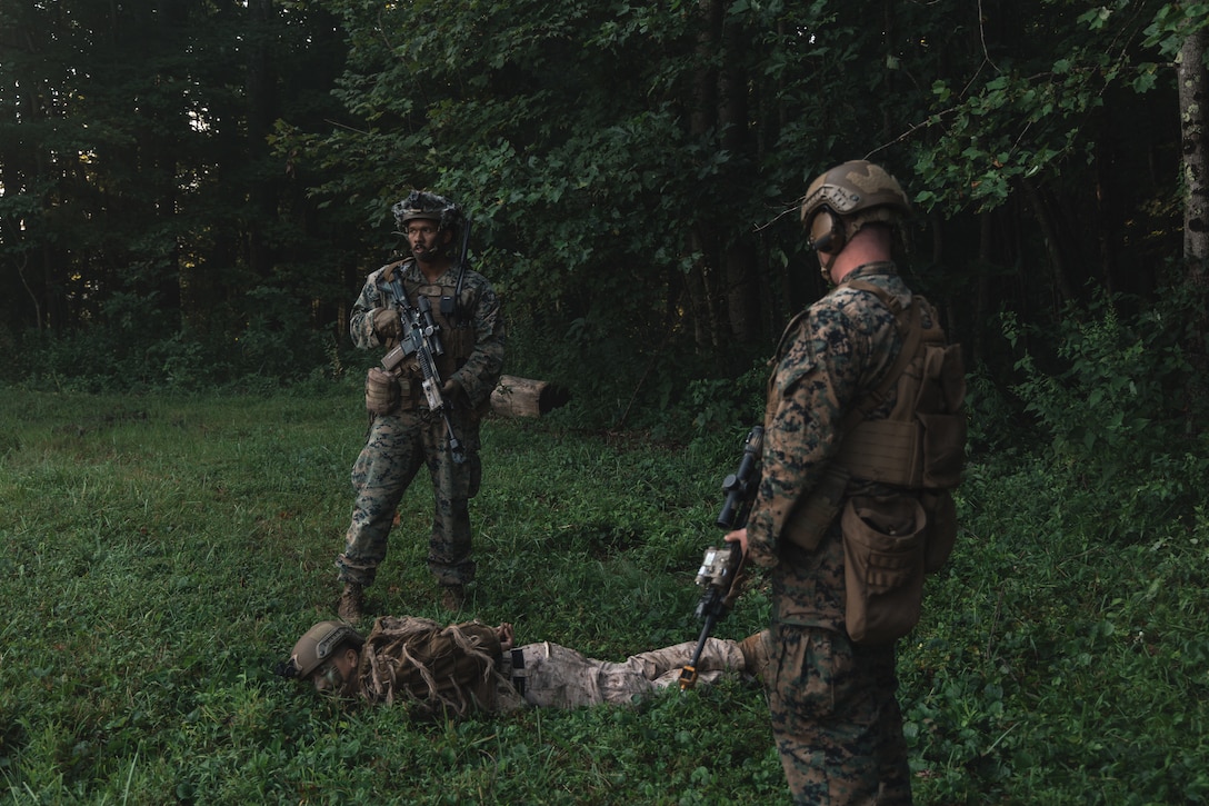 U.S. Marine Corps Lance Cpl. Nicholas Mangual, left, a rifleman with Golf Company, 2nd Battalion, 2nd Marine Regiment, and a North Carolina native, secures a role player acting as an enemy combatant during a mass casualty exercise at Camp Dawson, Kingwood, West Virginia, on Aug. 7, 2025. 2nd Bn., 2nd Marines, the ground combat element of the Special Purpose Marine Air-Ground Task Force-Alert Contingency MAGTF, traveled to Camp Dawson during a deployment for training and conducted various training evolutions to prepare for any potential MAGTF missions. (U.S. Marine Corps photo by Sgt. Jorge Borjas)