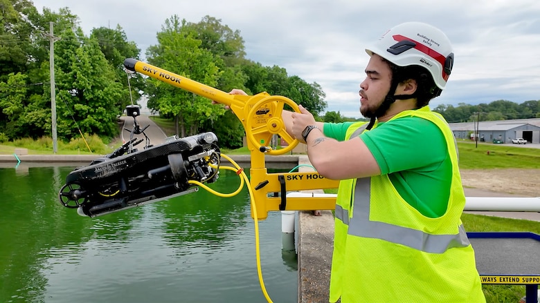 Brandon McGrew lowers the underwater remotely operated vehicle (ROV) down into a testing pond at the U.S. Army Engineer Research and Development Center in Vicksburg, Mississippi.