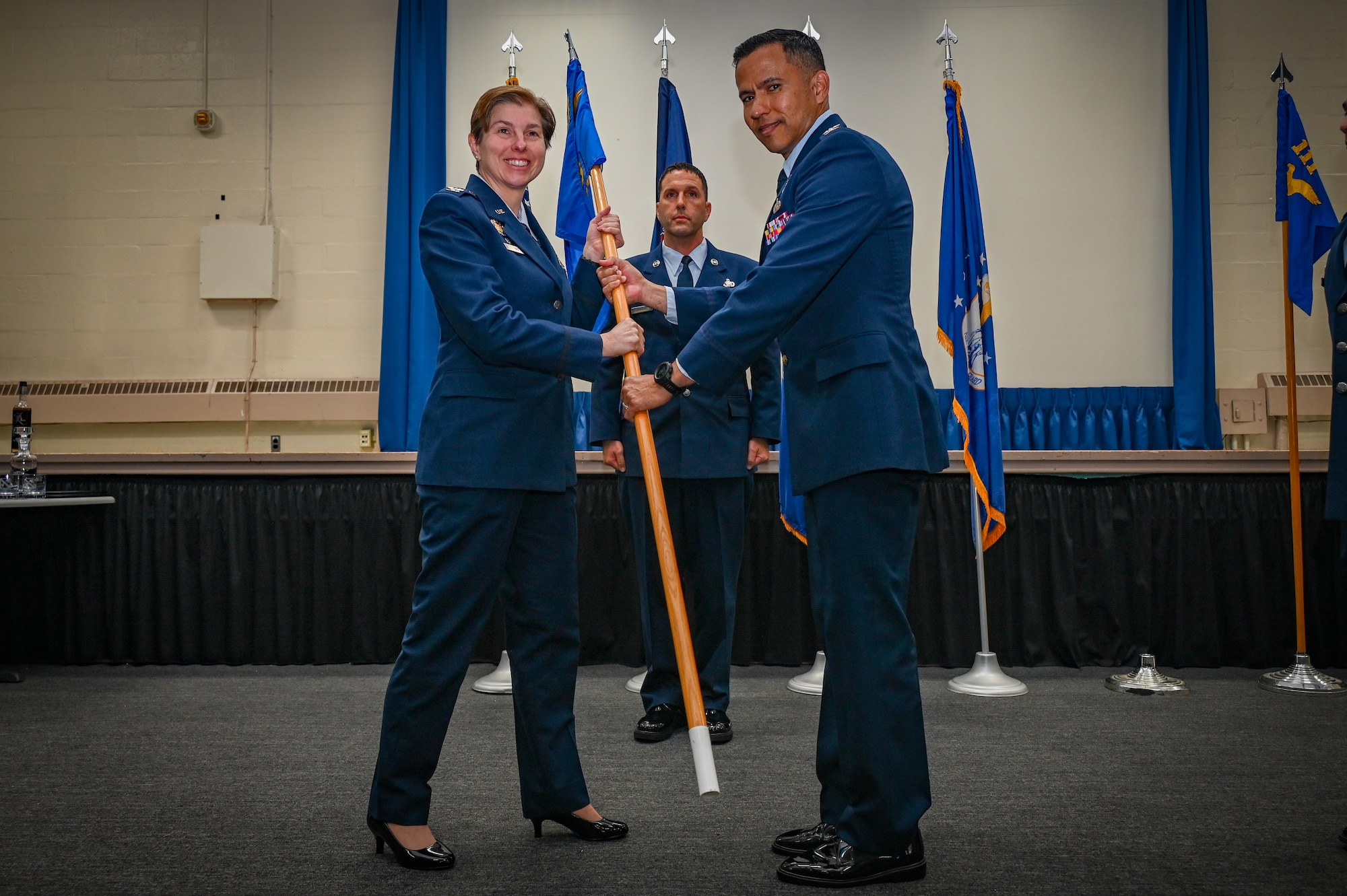 Pennsylvania Air National Guard Col. Col. Lynn Lee, 111th Attack Wing Commander, presents the 111th Mission Support Group guidon to U.S. ANG Col. Daniel Molina, the new 111th MSG Commander, during an assumption of command ceremony at Biddle Air National Guard Base in Horsham, Pennsylvania, Aug. 3, 2025.