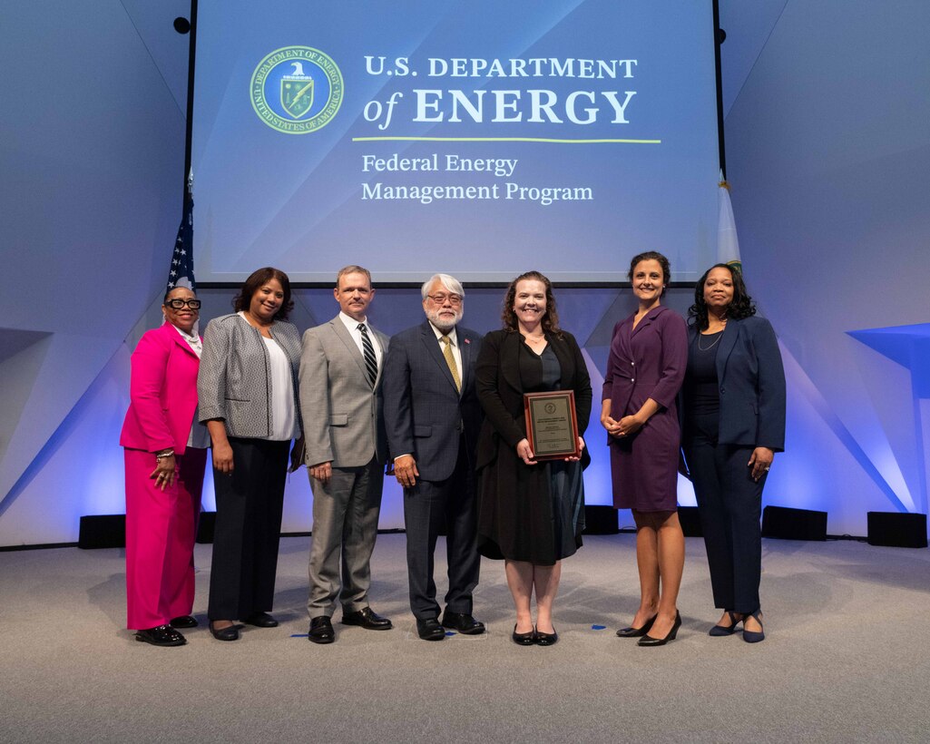 Melanie Johnson, with ERDC’s Construction Engineering Research Laboratory (CERL), stands among some of her colleagues after being honored with the Federal Energy Management Program (FEMP) Career Exceptional Service Award.