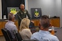U.S. Air Force Col. Chris Cain, 2nd Bomb Wing commander, gives a mission brief to honorary commanders