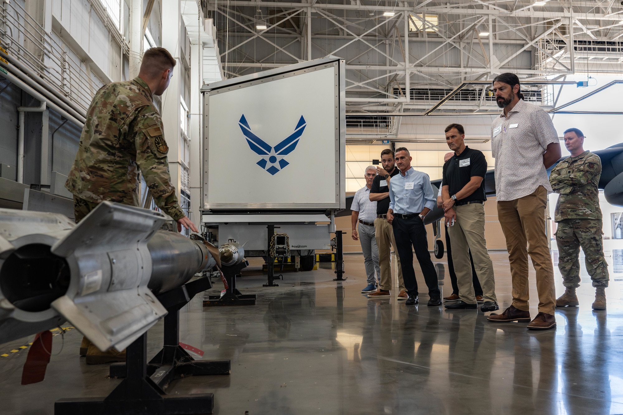 U.S. Air Force Senior Airman Dylan Keenan, 702nd Maintenance Squadron load crew team member, shows 2nd Bomb Wing honorary commanders various munitions