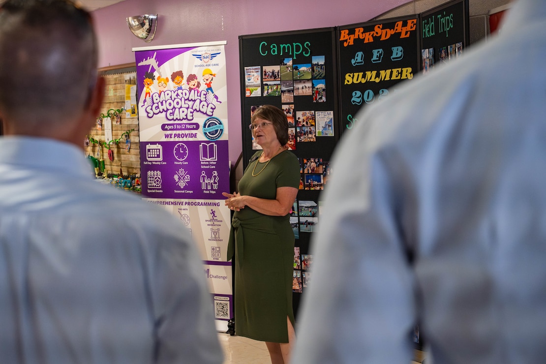 Penny Haire, Barksdale Youth Center assistant director, talks about the Youth Center to honorary commanders during a tour