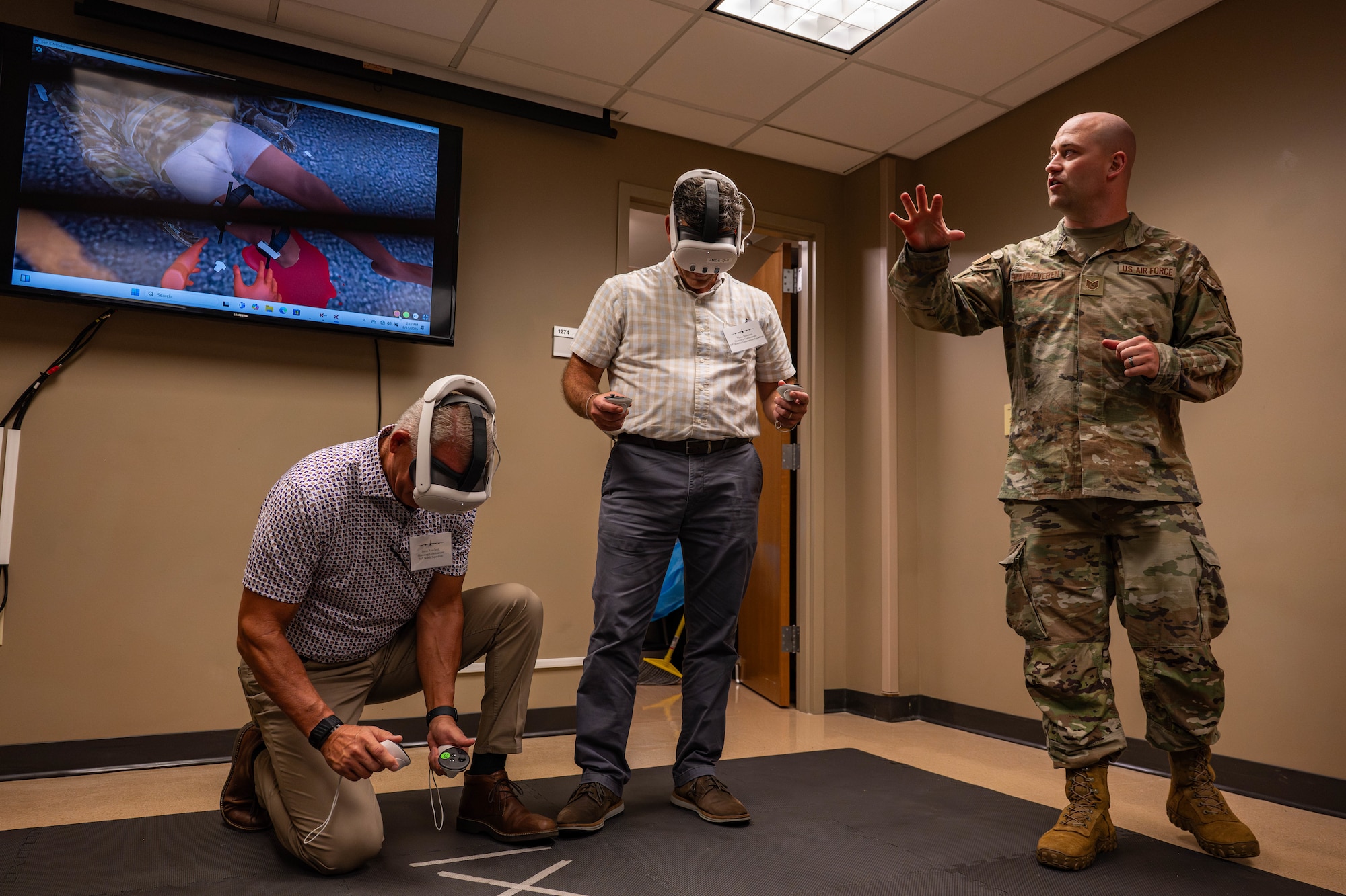 U.S. Air Force Tech. Sgt. Garret Vanmeveren, 2nd Medical Group education and training flight chief, shows honorary commanders a Tactical Combat Casualty Care simulator during a tour