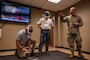 U.S. Air Force Tech. Sgt. Garret Vanmeveren, 2nd Medical Group education and training flight chief, shows honorary commanders a Tactical Combat Casualty Care simulator during a tour