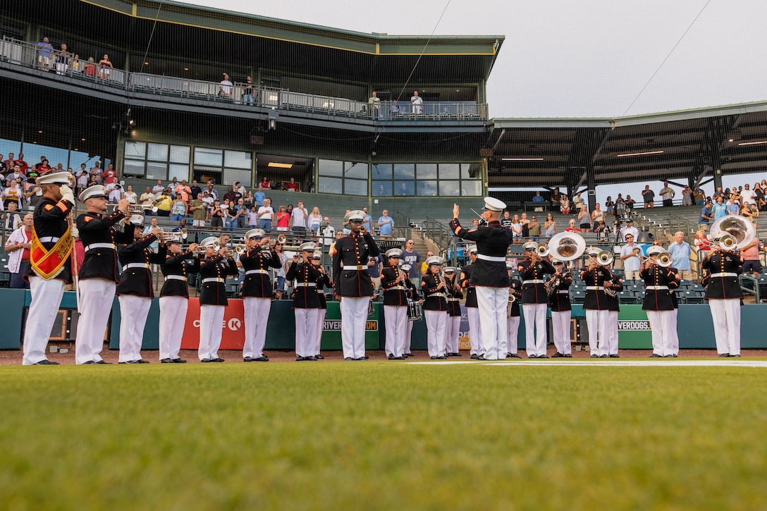 U.S. Marine musicians with the Parris Island Marine Band perform during a Charleston Riverdogs baseball game at Joseph P. Riley Jr. Park, Charleston, S.C., Aug 12, 2025. The Parris Island Marine Band performance during the game is part of an effort to help build community relations between the Marine Corps and its local communities, and honor our 250 year legacy. (U.S. Marine Corps photo by Lance Cpl. Jacob Claudell)