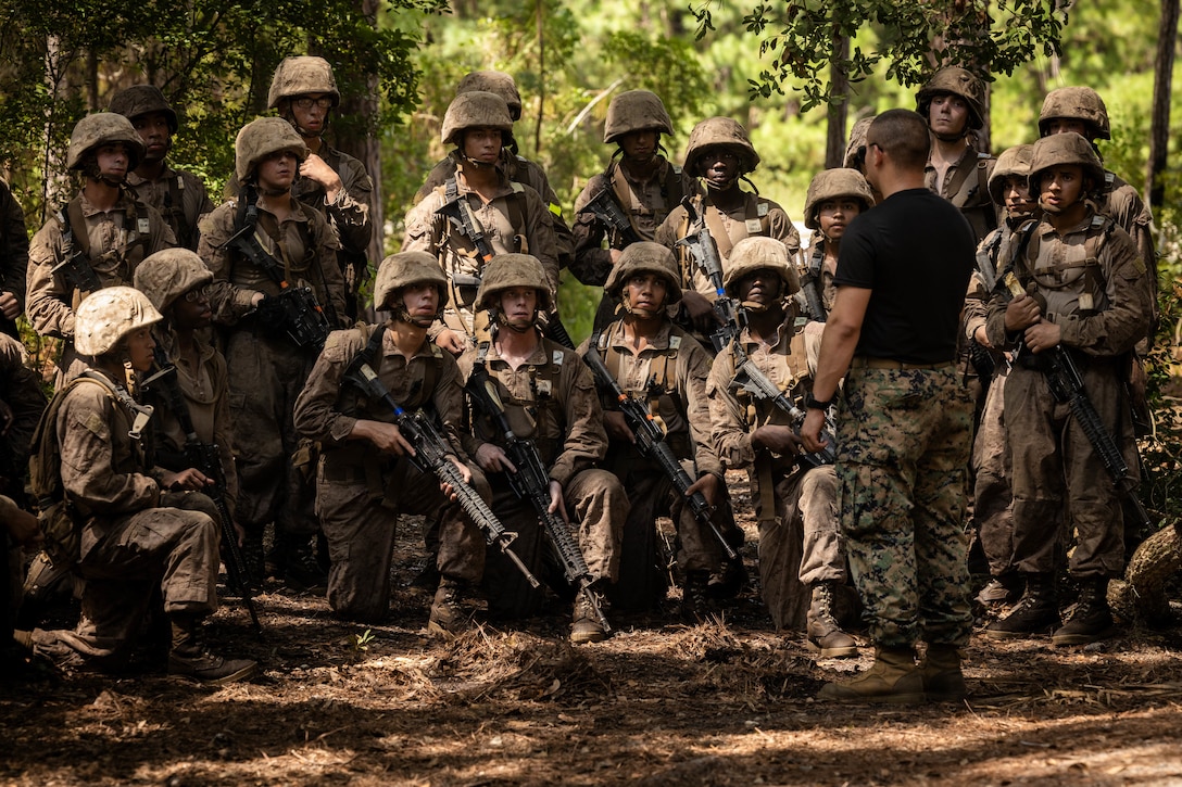 U.S. Marine Corps Lance Cpl. David Cuervo, an instructor with Weapons and Field Training Battalion, instructs recruits during the Crucible on Marine Corps Recruit Depot Parris Island, S.C., Aug. 15, 2025. The Crucible is the culmination of the knowledge and skills recruits learn throughout recruit training. (U.S. Marine Corps photo by Lance Cpl. Jacob Claudell)