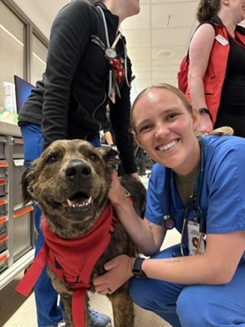 Cadet Madison Miller with a volunteer service dog