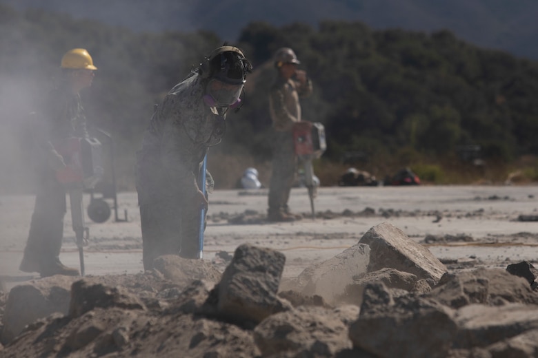 U.S. Marine Corps Cpl. Michael Roque, a combat engineer with Marine Wing Support Squadron 372, Marine Air Control Group 38, 3rd Marine Aircraft Wing, clears foreign objects and debris from an airfield at Vandenberg Space Force Base, California, Aug. 10, 2025. Operation Resilient Spear is an opportunity for Marines with MWSS-372 to integrate and train with Naval Mobile Construction Battalion 5, Naval Construction Force, through Base Recovery After Attack and Airfield Damage Repair Training to increase interoperability between Marine Corps engineers and Navy Seabees. Roque is a native of Virginia. (U.S. Marine Corps photo by Lance Cpl. Alexander Vaughn)