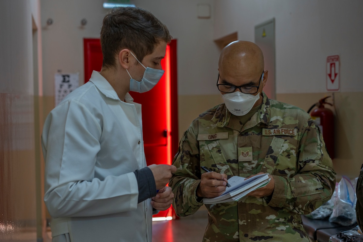Orlando Mestre Gonzalez, Paraguayan medical student and AMISTAD volunteer, discusses patient intake with U.S. Air Force Staff Sgt. Wutchu Ung at Unidad de Salud de la Familia Inmaculada Concepción in Luque, Paraguay, Aug. 11, 2025. During AMISTAD 2025, volunteers were essential to connecting medical teams with patients by providing translation and administrative support. (U.S. Air Force photo by Andrea Jenkins)