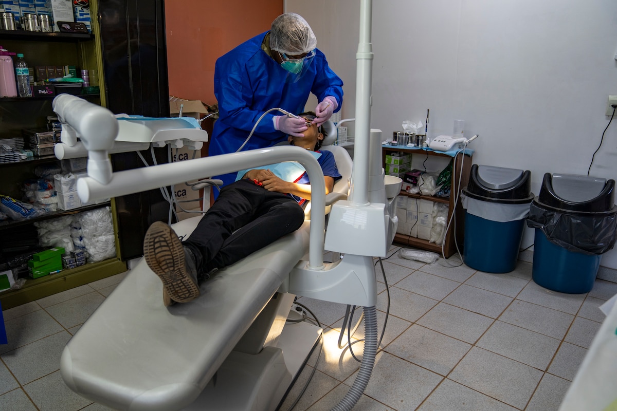 A U.S. Air Force dental technician using newly donated equipment at the Unidad de Salud de la Familia Tarumandy in Luque, Paraguay, Aug. 13, 2025. The donation made by U.S. Southern Command and the U.S. Embassy in Asuncion marked the first time the community had a reliable dental option, part of a broader U.S.-Paraguayan effort to improve healthcare access. (U.S. Air Force photo by Andrea Jenkins)