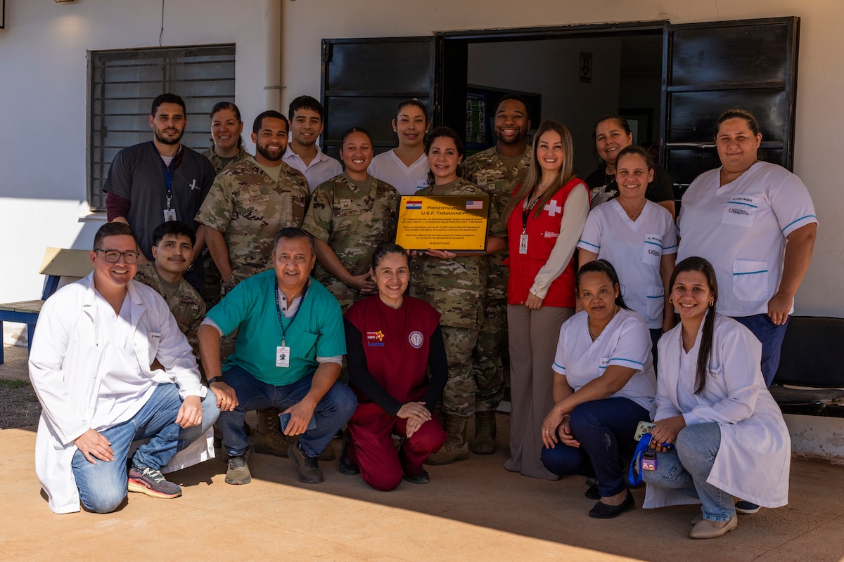 U.S. and Paraguayan medical teams pose for a group photo after a donation ceremony at the Unidad de Salud de la Familia Tarumandy in Luque, Paraguay, Aug. 13, 2025. U.S. Southern Command and the U.S. Embassy donated a full dental suite and thousands of prescription eyeglasses, strengthening healthcare partnerships. (U.S. Air Force photo by Andrea Jenkins)
