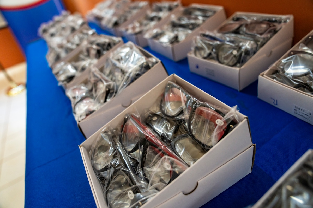 Boxes of prescription eyeglasses are displayed during a donation ceremony at the Unidad de Salud de la Familia Tarumandy in Luque, Paraguay, Aug. 13, 2025. More than 17,000 pairs were provided by U.S. Southern Command and the U.S. Embassy, ensuring residents with vision impairments receive potentially life-altering support. (U.S. Air Force photo by Andrea Jenkins)