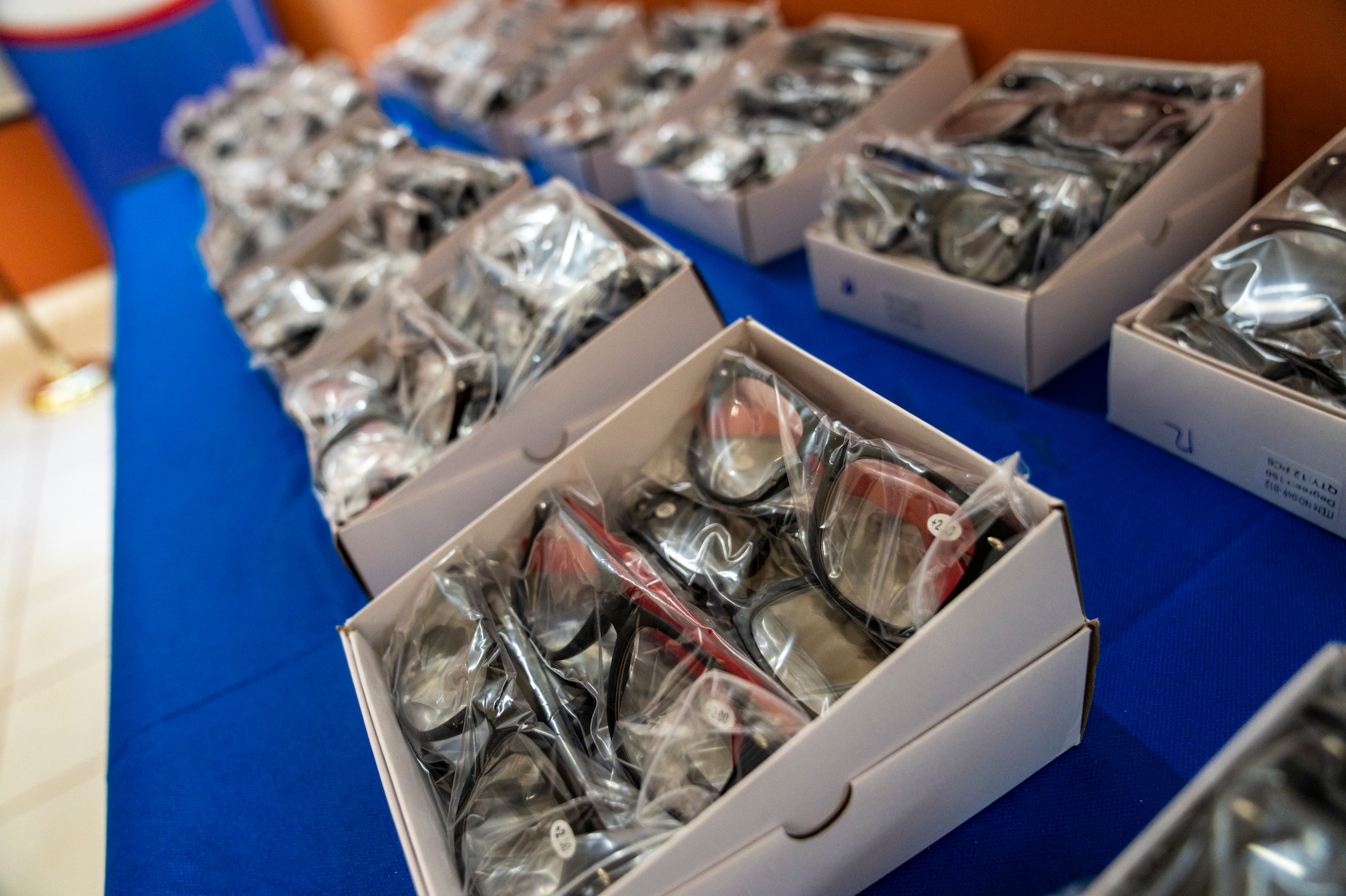 Boxes of prescription eyeglasses are displayed during a donation ceremony at the Unidad de Salud de la Familia Tarumandy in Luque, Paraguay, Aug. 13, 2025. More than 17,000 pairs were provided by U.S. Southern Command and the U.S. Embassy, ensuring residents with vision impairments receive potentially life-altering support. (U.S. Air Force photo by Andrea Jenkins)