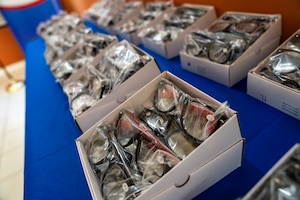 Boxes of prescription eyeglasses are displayed during a donation ceremony at the Unidad de Salud de la Familia Tarumandy in Luque, Paraguay, Aug. 13, 2025. More than 17,000 pairs were provided by U.S. Southern Command and the U.S. Embassy, ensuring residents with vision impairments receive potentially life-altering support. (U.S. Air Force photo by Andrea Jenkins)