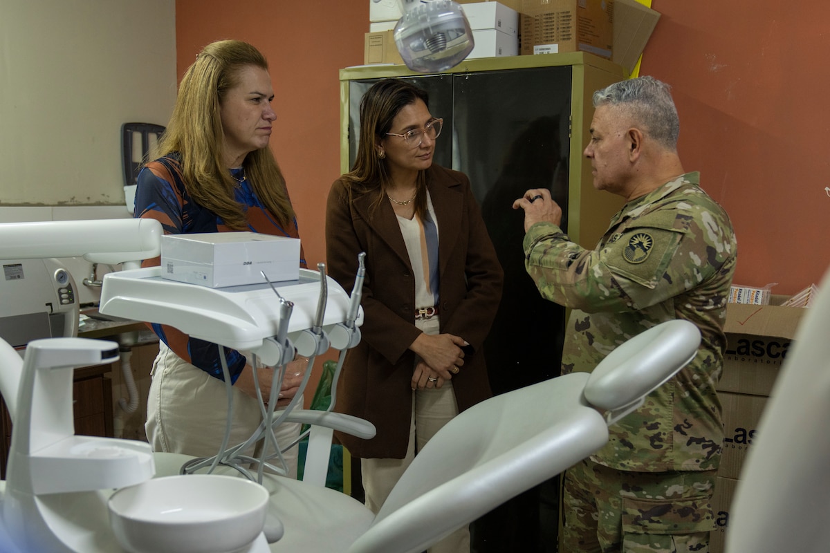 U.S. Army Maj. Gen. Javier Reina, Deputy Commander for Mobilization and Reserve Affairs, U.S. Southern Command, speaks with Paraguayan officials during a clinic walkthrough in Luque, Paraguay, Aug. 13, 2025. Reina emphasized the donation was about more than equipment — it was about building lasting healthcare capacity. (U.S. Air Force photo by Andrea Jenkins)