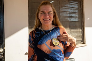 Paraguayan Minister of Health Dr. Maria Teresa Baran displays an AMISTAD 2025 patch following a donation ceremony in Luque, Paraguay, Aug. 13, 2025. The ceremony marked the delivery of a fully equipped dental suite and 17,000 pairs of prescription eyeglasses to the Ministry of Health. (U.S. Air Force photo by Andrea Jenkins)