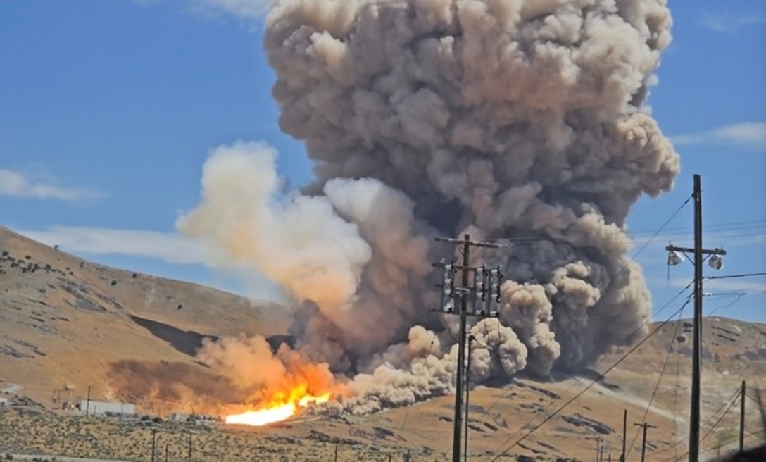 Photo of a live fire in the middle of a desert.