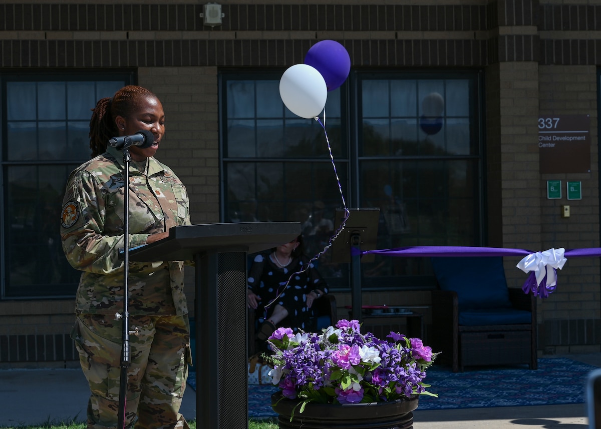 A woman in a military uniform speaks at a podium.