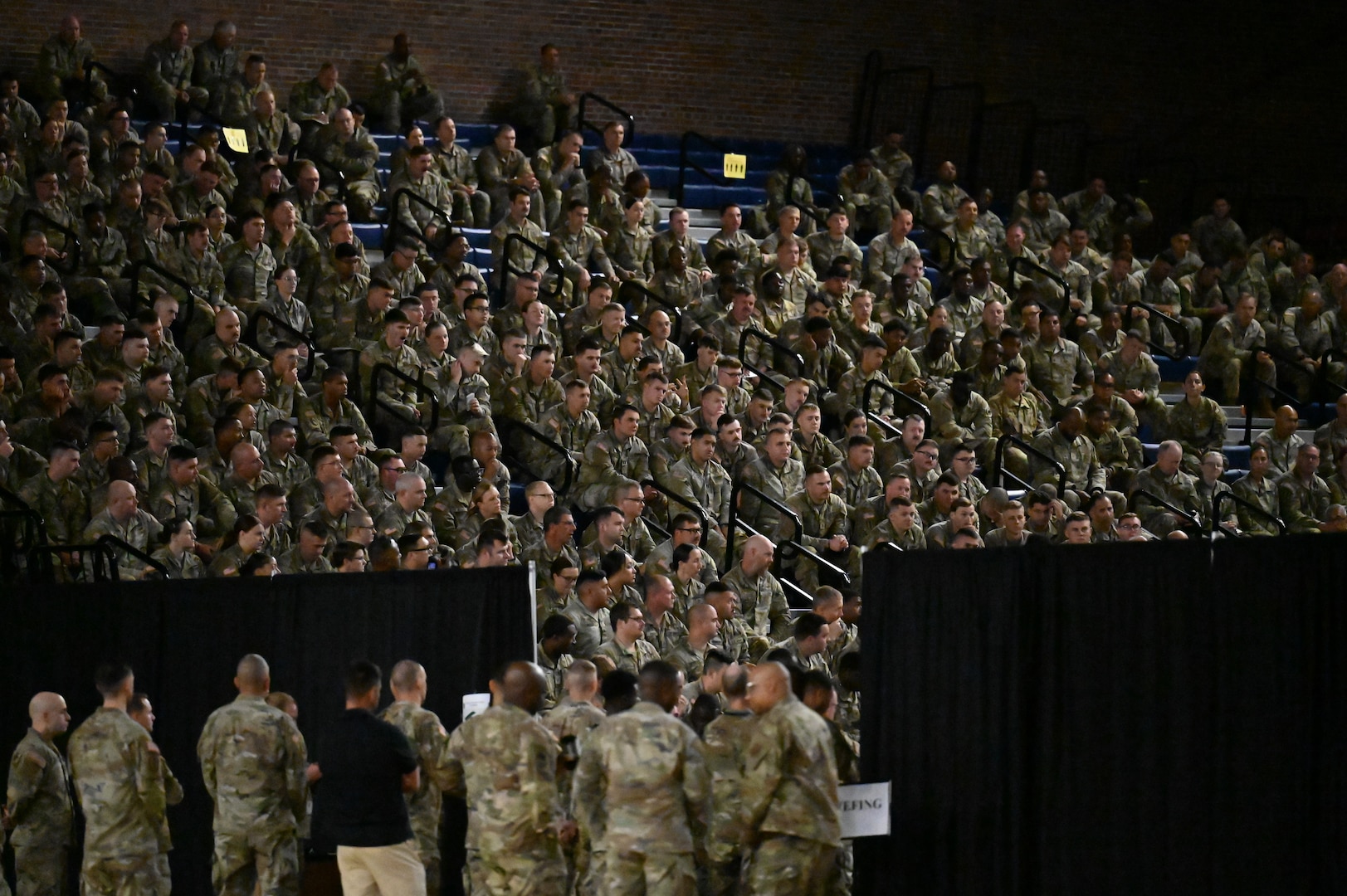 Crowd shots of people in military camo uniform