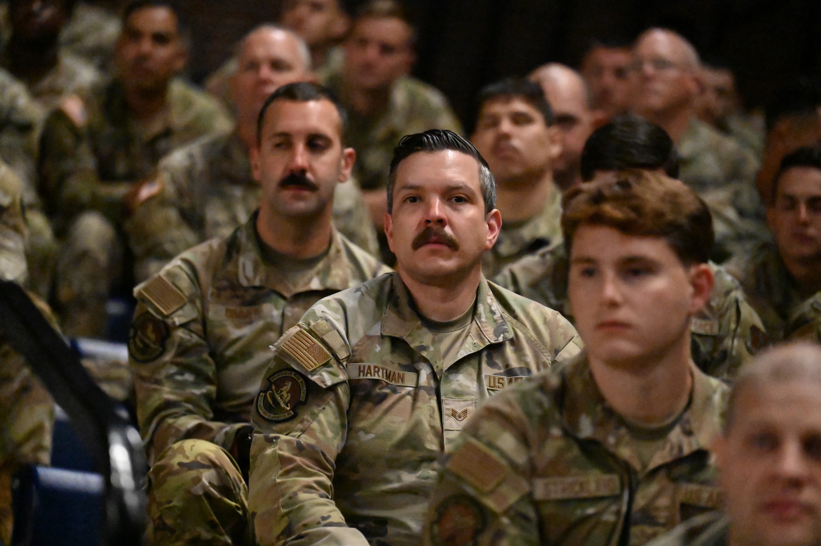 Crowd shots of people in military camo uniform