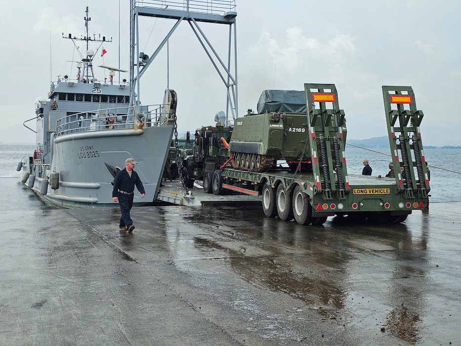 A U.S. Army Landing Craft Utility (LCU) conducts the first-ever roll-on/roll-off operation at JTDC Subic Shared North Dock in the Philippines, loading an armored personnel carrier during SABAK 25, marking a milestone in joint maritime logistics and operational capability.