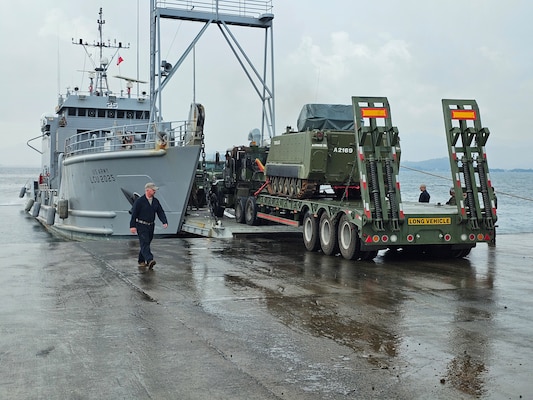 A U.S. Army Landing Craft Utility (LCU) conducts the first-ever roll-on/roll-off operation at JTDC Subic Shared North Dock in the Philippines, loading an armored personnel carrier during SABAK 25, marking a milestone in joint maritime logistics and operational capability.