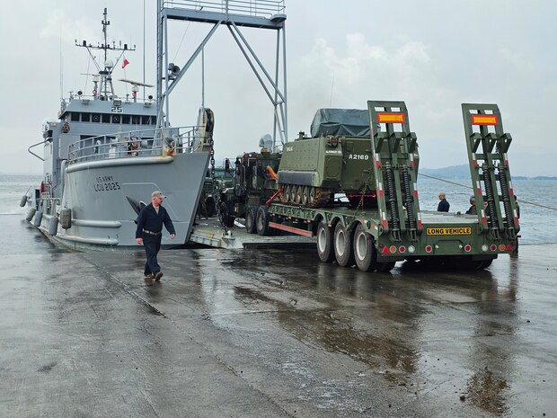 A U.S. Army Landing Craft Utility (LCU) conducts the first-ever roll-on/roll-off operation at JTDC Subic Shared North Dock in the Philippines, loading an armored personnel carrier during SABAK 25, marking a milestone in joint maritime logistics and operational capability.