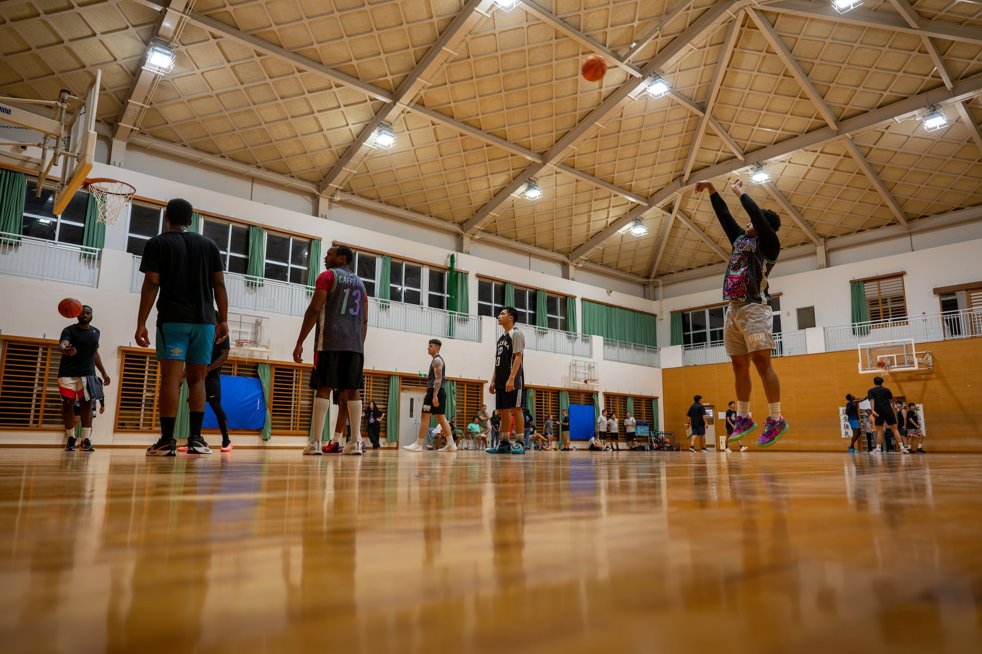 The 18 CS basketball team warms up before a basketball match with the Okinawan prefectural representative team