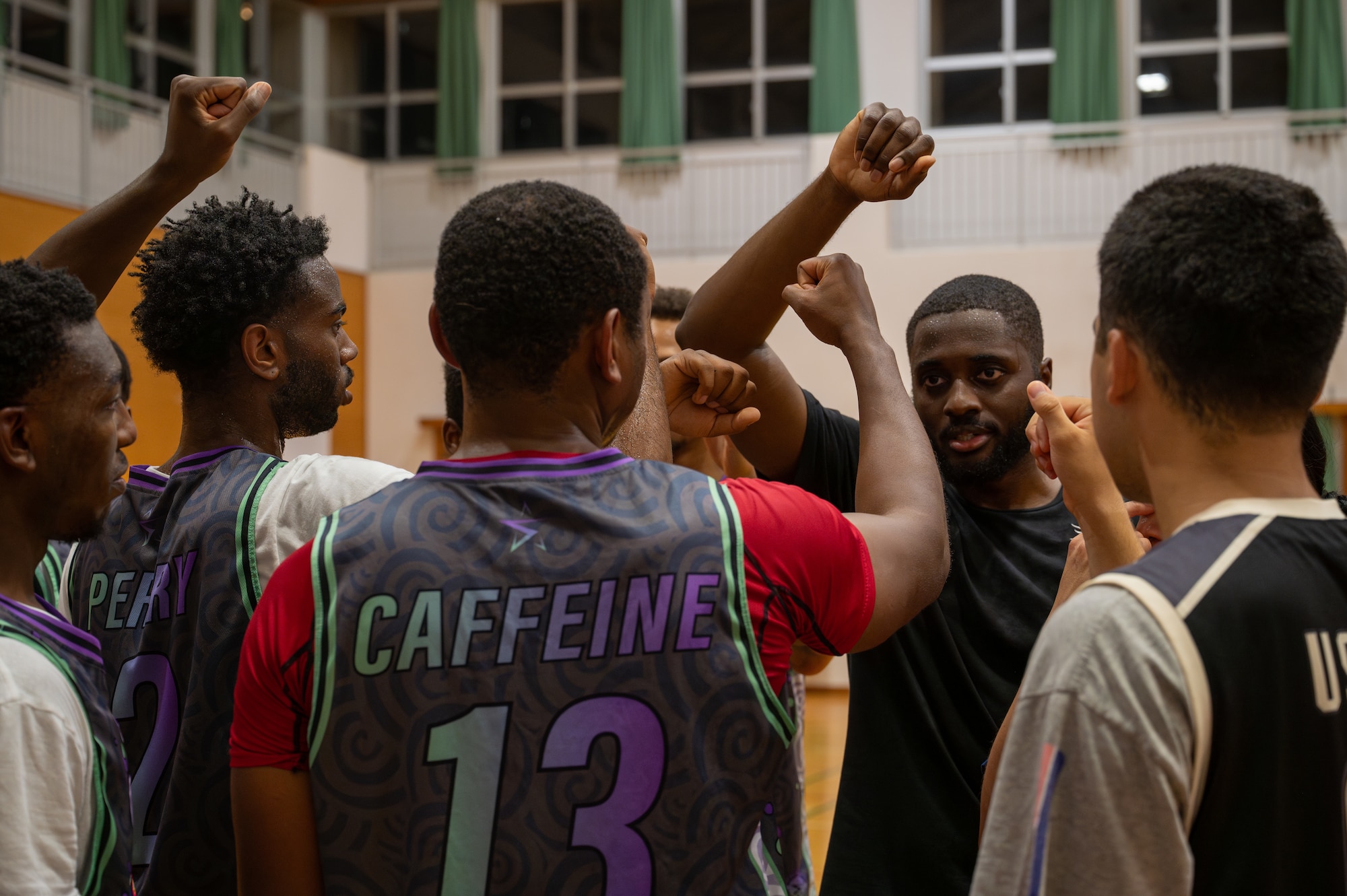 The coach for the 18 CS basketball team rallies them before the game