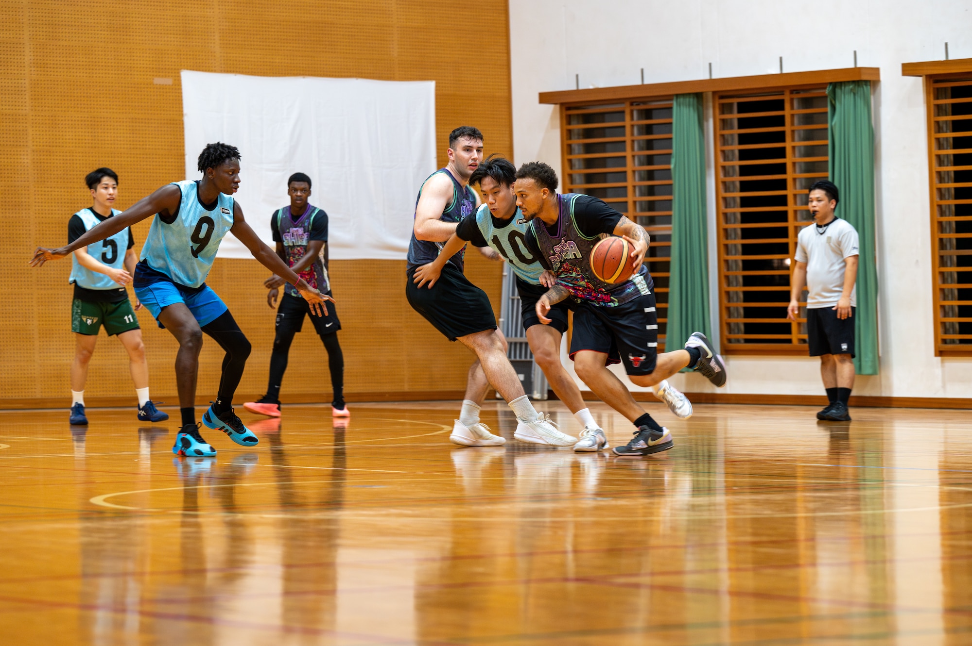 An Airman with 18 CS dribbles down the court