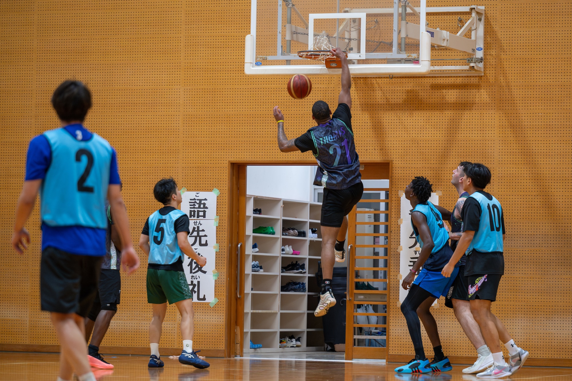 Airman from 18th CS slam dunks on the court
