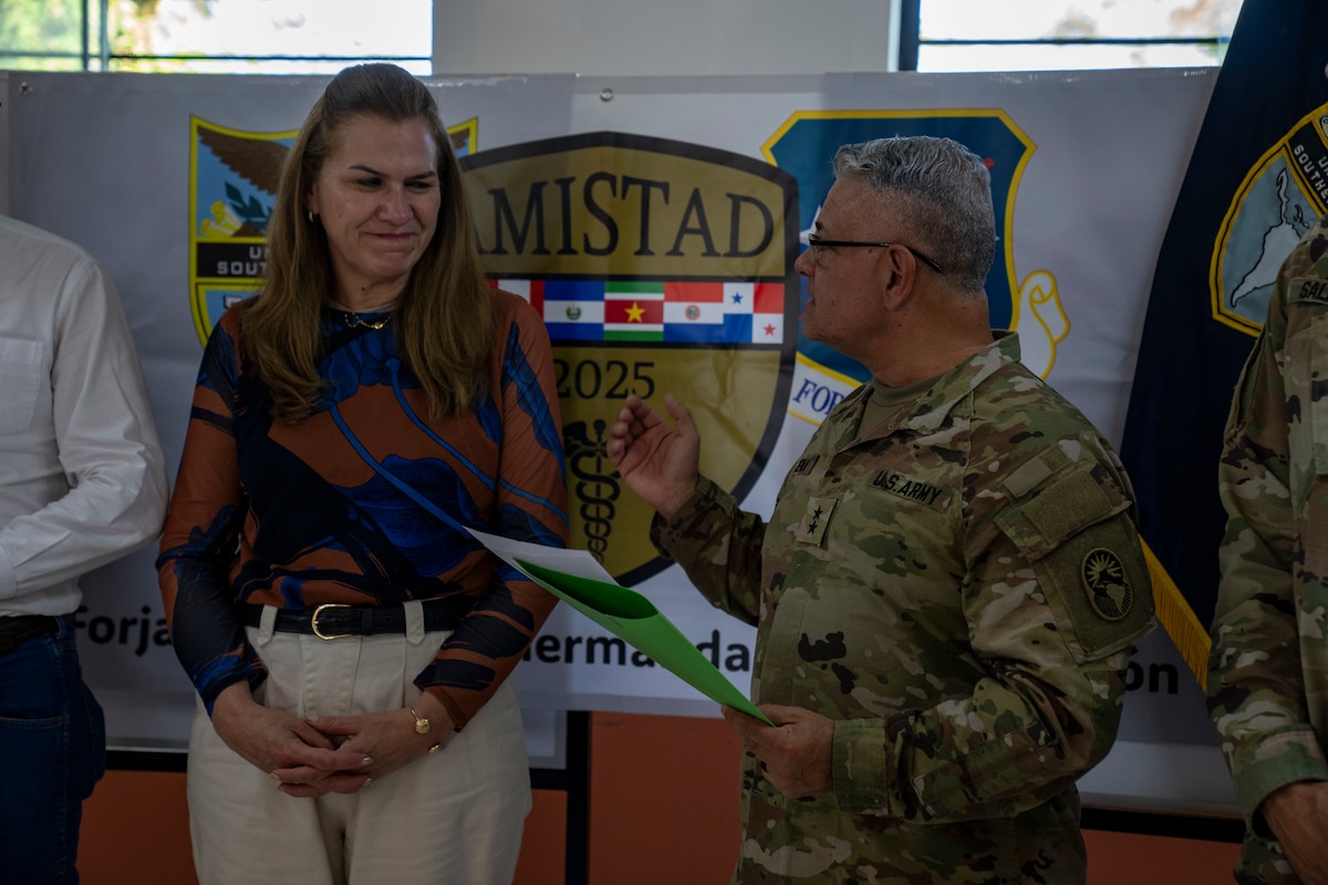U.S. Army Maj. Gen. Javier Reina, Deputy Commander for Mobilization and Reserve Affairs, U.S. Southern Command, talks to Paraguayan Minister of Health Dr. Maria Teresa Baran during a donation ceremony at the Unidad de Salud de la Familia Tarumandy in Luque, Paraguay, Aug. 13, 2025. The donation will expand access to dental and vision care for the community of Tarumandy. (U.S. Air Force photo by Andrea Jenkins)