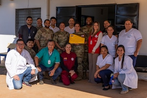 U.S. and Paraguayan medical teams pose for a group photo after a donation ceremony at the Unidad de Salud de la Familia Tarumandy in Luque, Paraguay, Aug. 13, 2025. U.S. Southern Command and the U.S. Embassy donated a full dental suite and thousands of prescription eyeglasses, strengthening healthcare partnerships. (U.S. Air Force photo by Andrea Jenkins)