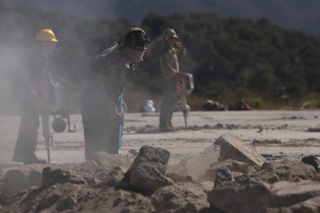 U.S. Marine Corps Cpl. Michael Roque, a combat engineer with Marine Wing Support Squadron 372, Marine Air Control Group 38, 3rd Marine Aircraft Wing, clears foreign objects and debris from an airfield at Vandenberg Space Force Base, California, Aug. 10, 2025. Operation Resilient Spear is an opportunity for Marines with MWSS-372 to integrate and train with Naval Mobile Construction Battalion 5, Naval Construction Force, through Base Recovery After Attack and Airfield Damage Repair Training to increase interoperability between Marine Corps engineers and Navy Seabees. Roque is a native of Virginia. (U.S. Marine Corps photo by Lance Cpl. Alexander Vaughn)