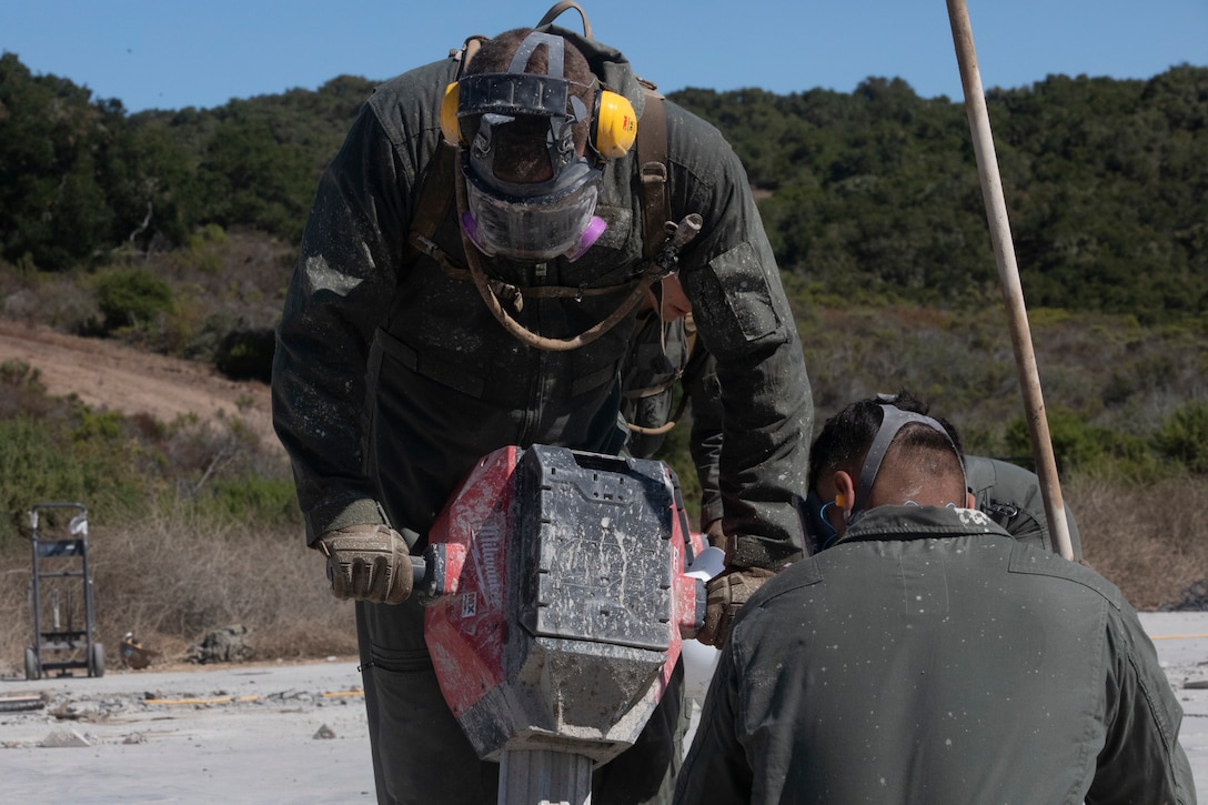 U.S. Marine Corps Pfc. Roberto Heredia Ramirez, a combat engineer with Marine Wing Support Squadron 372, Marine Air Control Group 38, 3rd Marine Aircraft Wing, uses a jackhammer on an airfield during Operation Resilient Spear at Vandenberg Space Force Base, California, Aug. 10, 2025. Operation Resilient Spear is an opportunity for Marines with MWSS-372 to integrate and train with Naval Mobile Construction Battalion 5, Naval Construction Force, through Base Recovery After Attack and Airfield Damage Repair Training to increase interoperability between Marine Corps engineers and Navy Seabees. Heredia Ramirez is a native of Cuba. (U.S. Marine Corps photo by Lance Cpl. Alexander Vaughn)