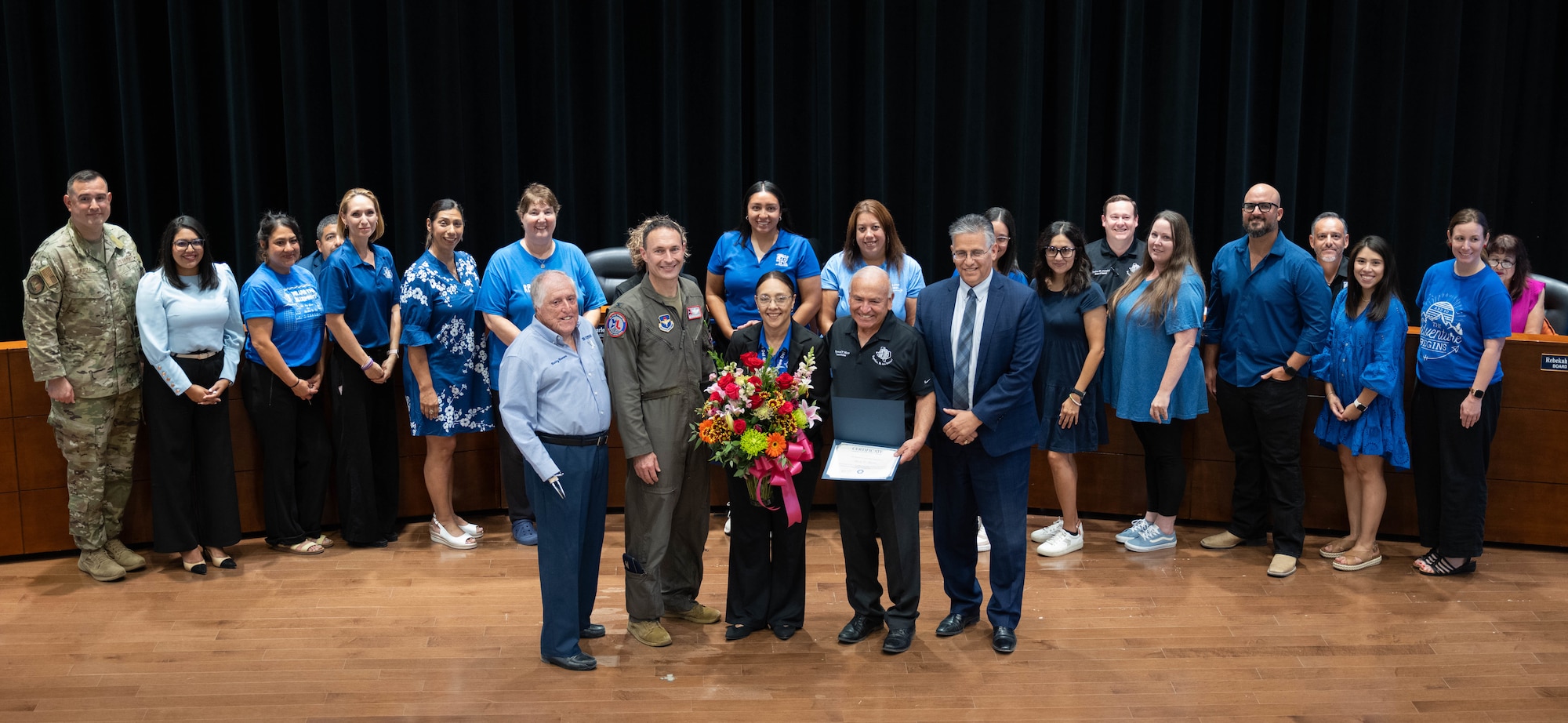Roberto ”Bobby” Barrera, RBB Elementary STEM Magnet School faculty and staff, Laughlin Air Force Base leadership and San Felipe Del Rio Consolidated Independent School District (SFDRCISD) school board members pose together for a group photo in Del Rio, Texas, Aug. 18, 2025.  RBB were honored by Team XL and SFRDCISD for being named a 2025 Blue Ribbon Lighthouse School. (U.S. Air Force photo by Capt. Christine Del Aguila.)