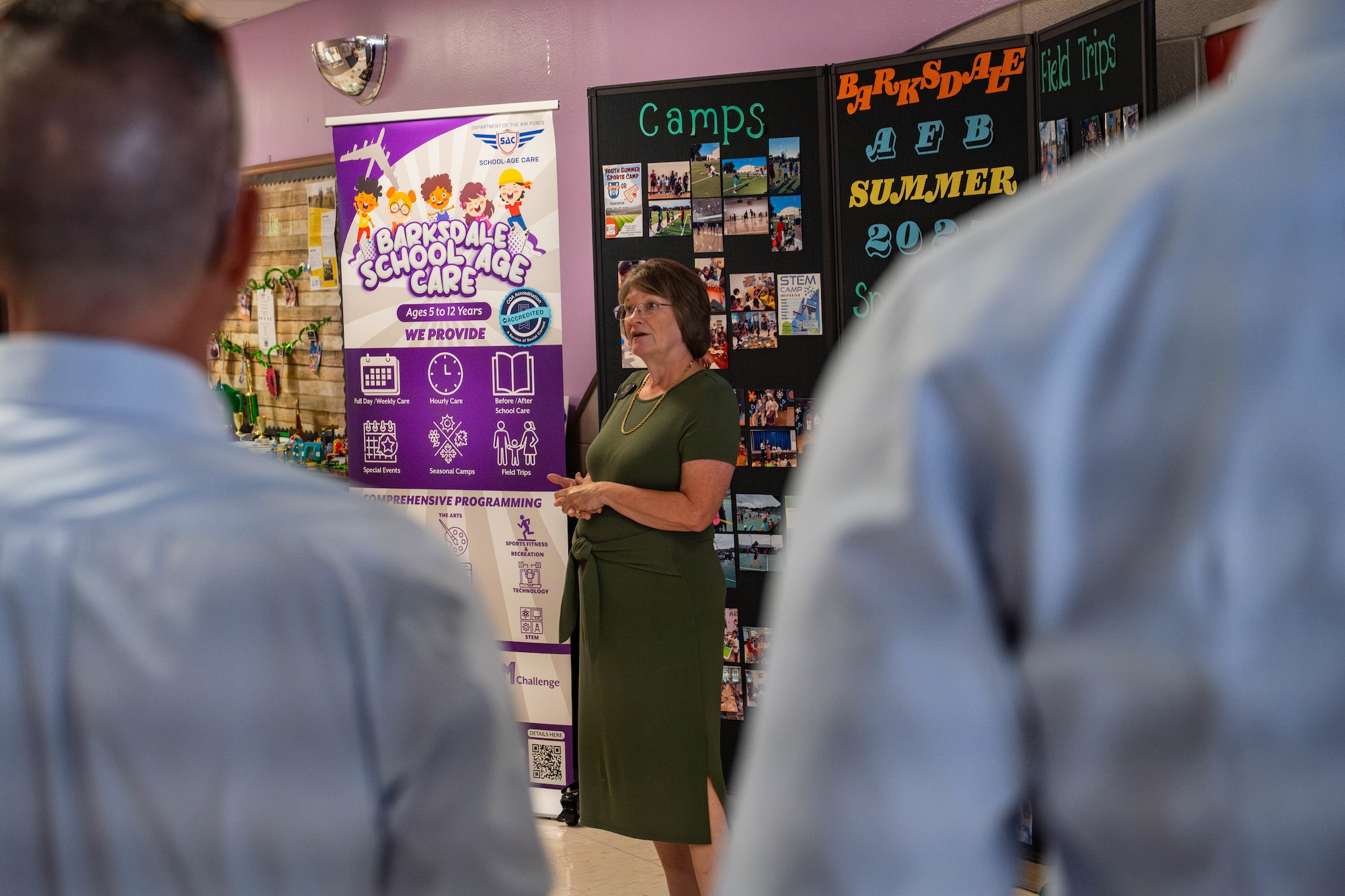 Penny Haire, Barksdale Youth Center assistant director, talks about the Youth Center to honorary commanders during a tour