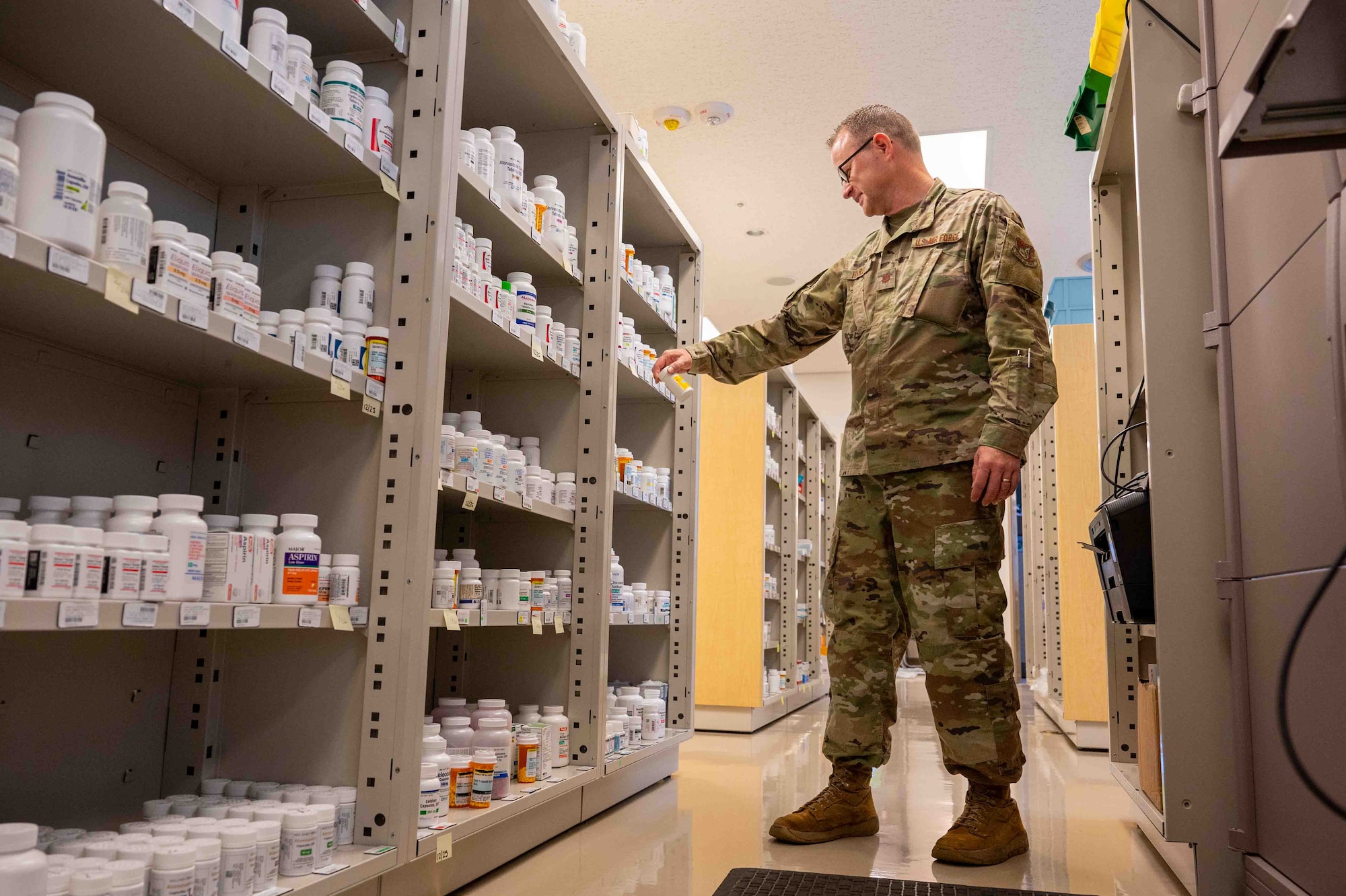 A service member looks for a prescription.
