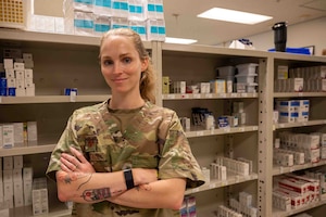 A service member poses for a photo